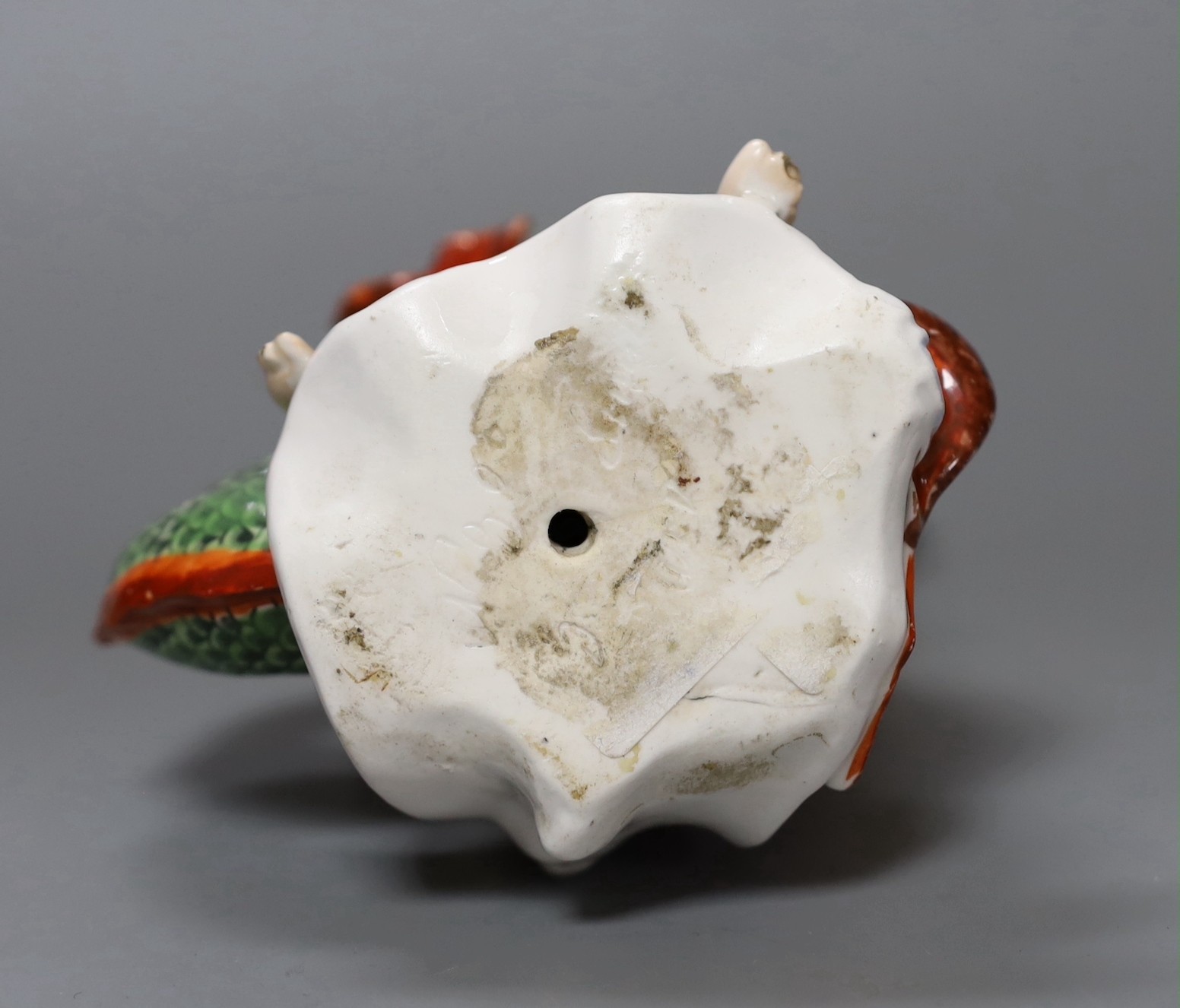 A Derby figure of Neptune and a dolphin, 17cm tall
